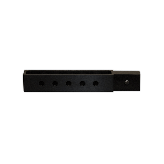 Close-up of a black rectangular boom height adjuster with multiple holes for adjustable positioning.