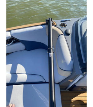 Deluxe Gunnel Mount Boom standing upright, stowed inside a boat by the seats.