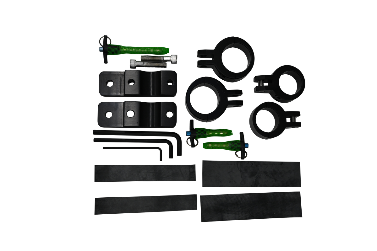 Close-up of Tower Boom clamp kit with black brackets, green pins, bolts, and a silver tube insert.