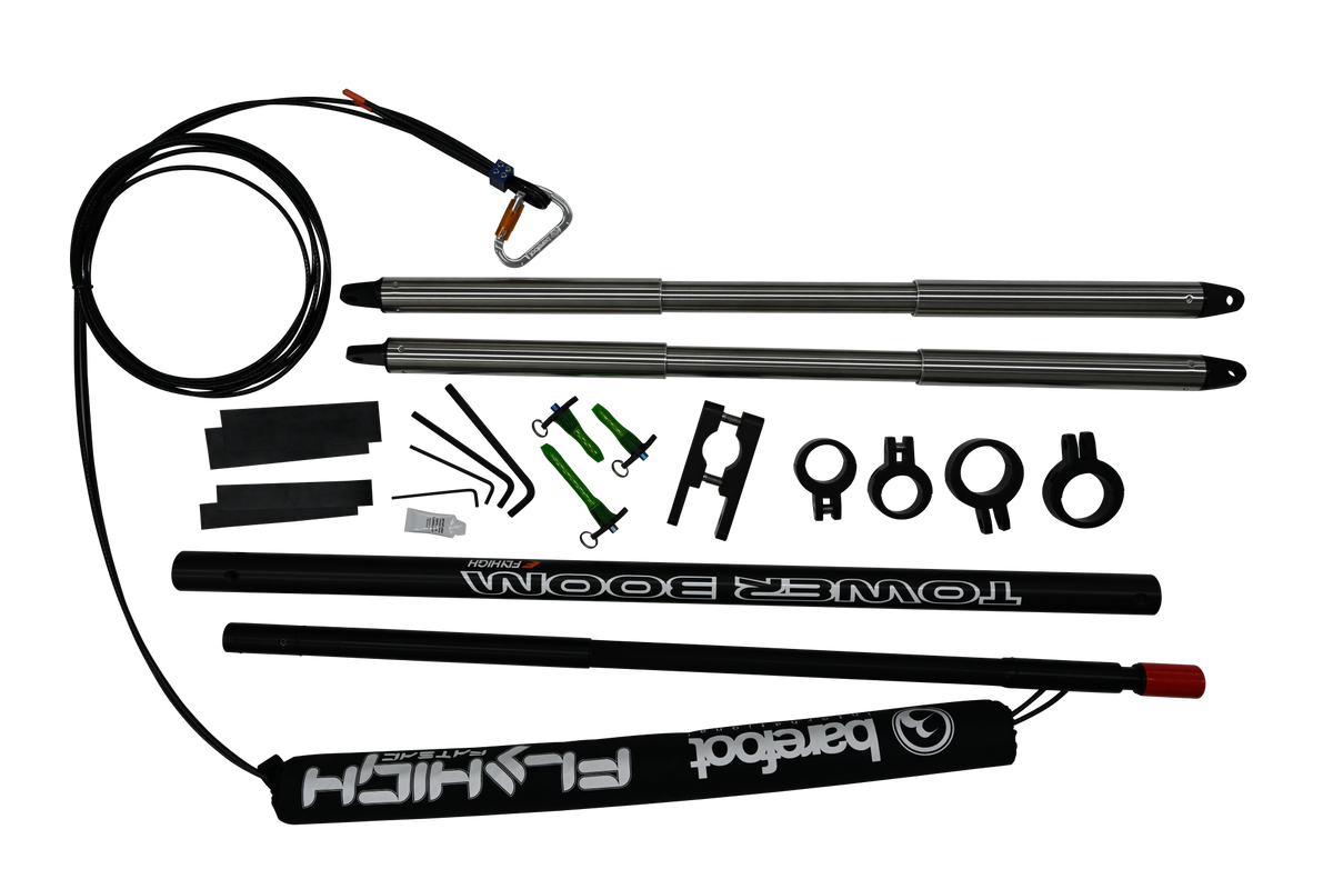 Angled view of Refurbished Tower Boom with black and silver boom poles, clamps, green pins, and padded cover.