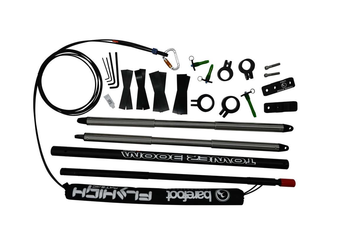 Angled view of Tower Boom with silver poles, black boom arms, clamps, green pins, and padded cover.