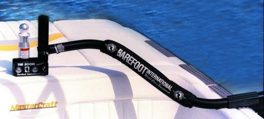 Deluxe Quad V-Drive Boom mounted along the side of a white boat over the water.